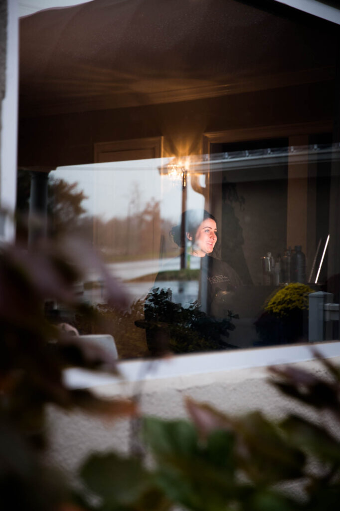 Bride getting her final bridal makeup touch-ups in a professional makeup studio.