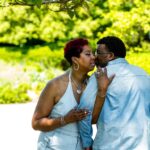 Engaged couple enjoying a sunny outdoor engagement photography session.